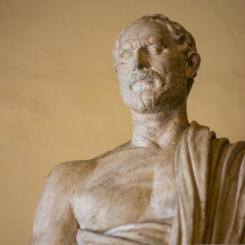 A statue of a man with a beard and a robe