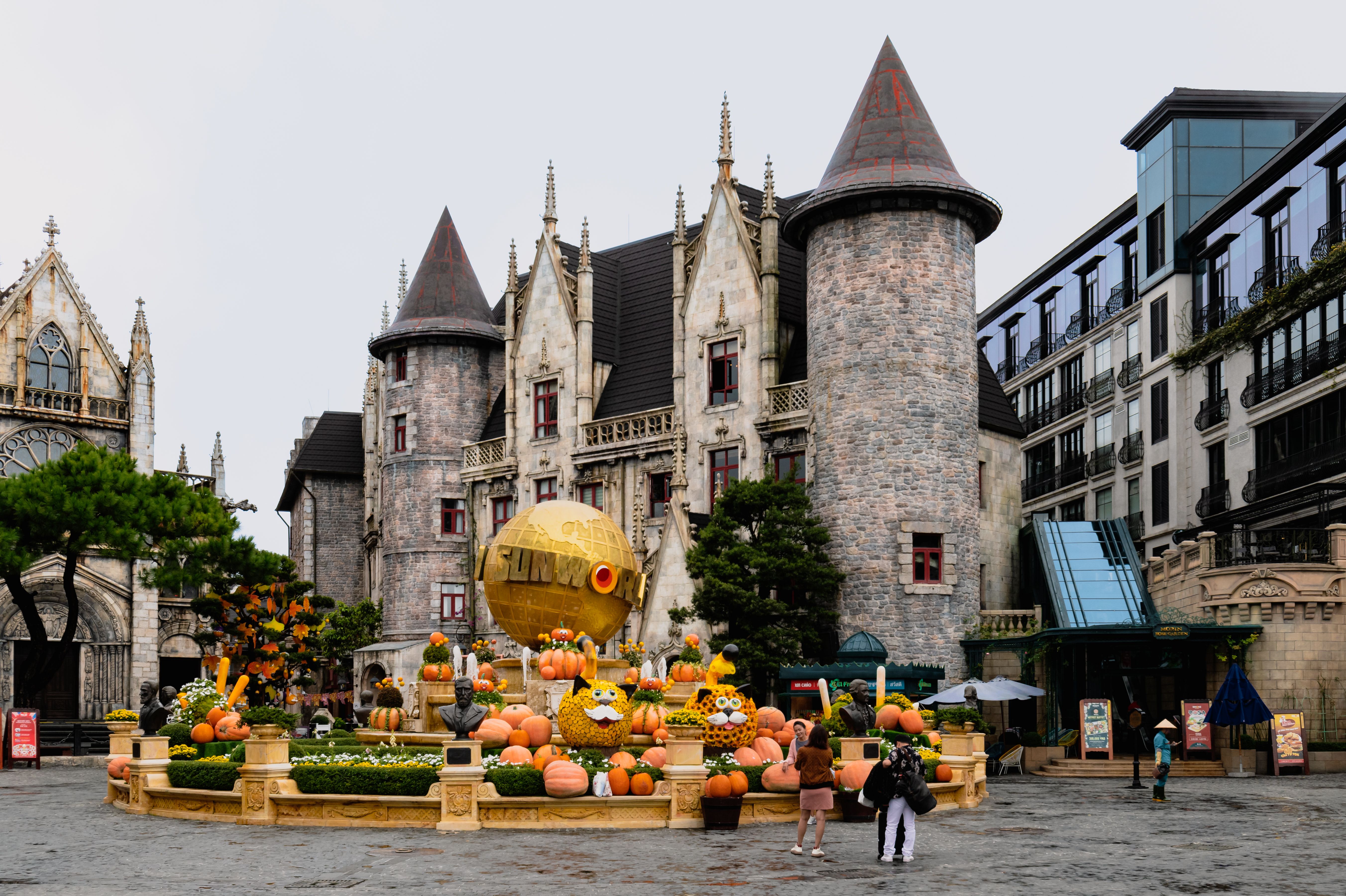 Charming castle with festive pumpkins at Ba Na Hills, Da Nang, Vietnam, perfect for a magical travel experience.