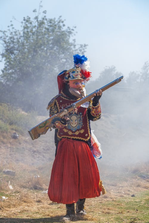 A man in a costume holding a gun