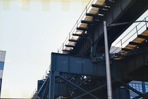 Free A detailed view of an iron railway bridge against a clear blue sky in New York City. Stock Photo