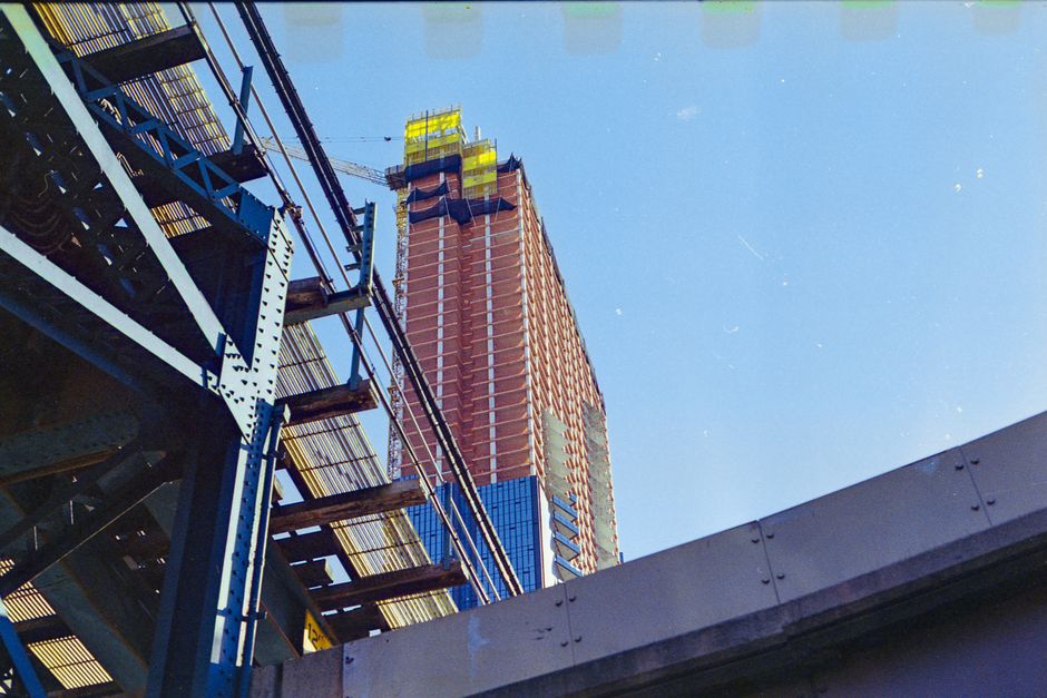 Low angle view of a skyscraper under construction with metal scaffolding in NYC.