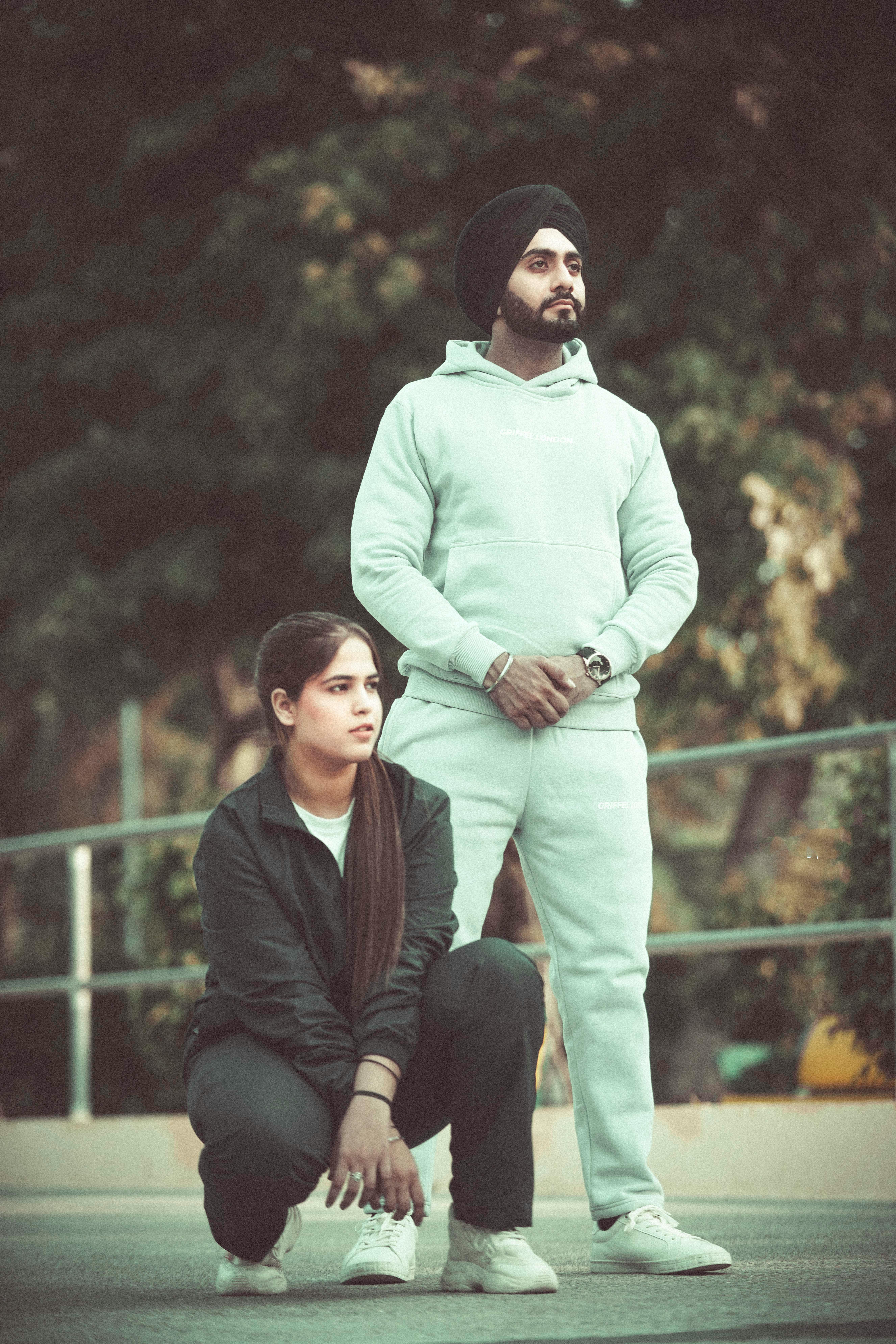 A man and woman pose stylishly with an outdoor backdrop in Chandigarh, India.