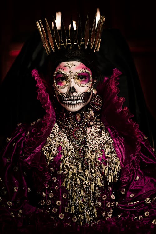 A woman dressed in a skeleton costume with a crown