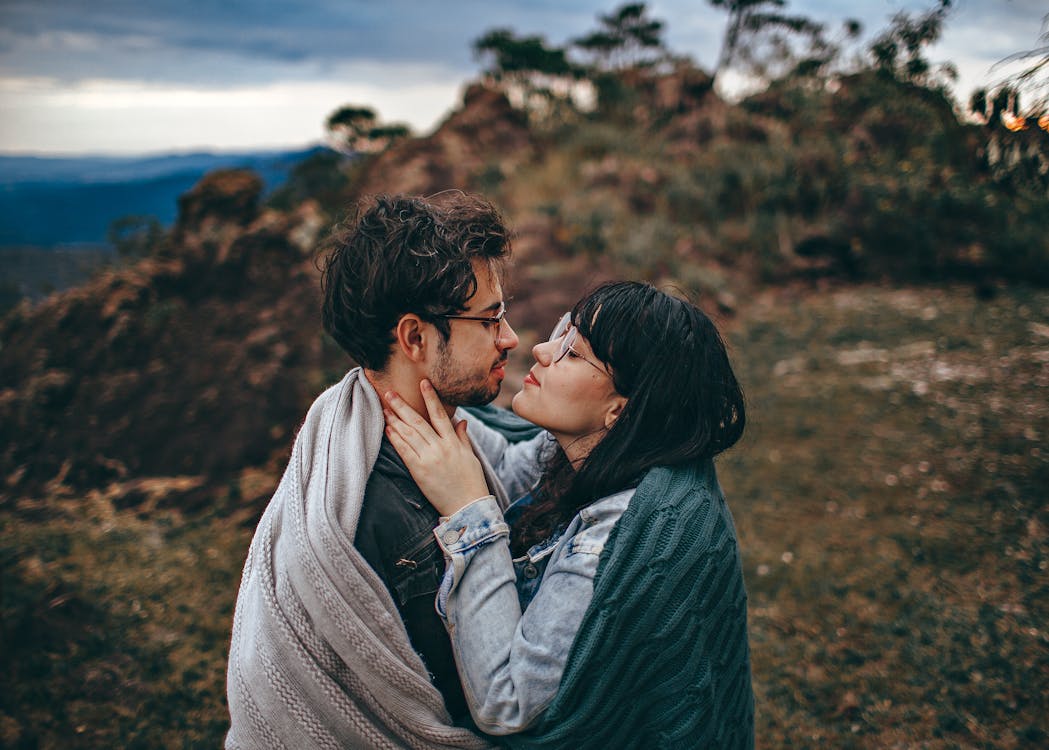 Free Woman Sharing Blanket With Man Stock Photo