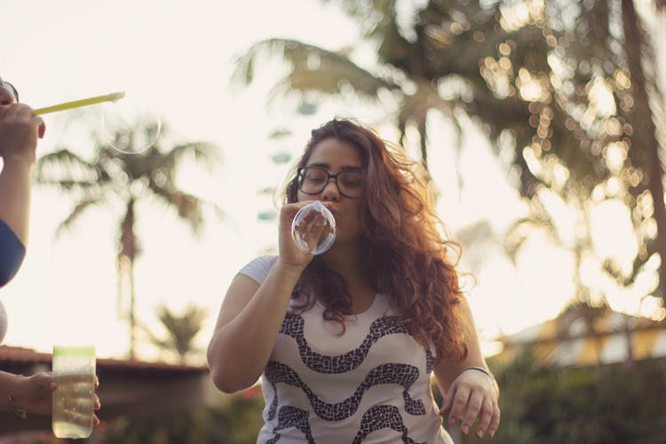 Photo Of Woman Blowing Bubbles