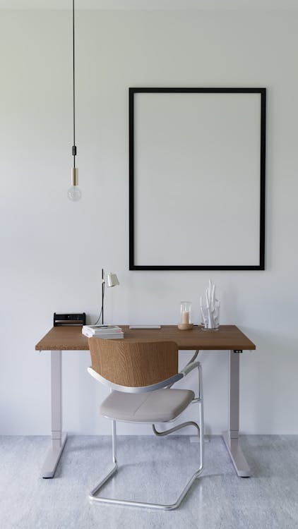 A white desk with a chair and a picture frame