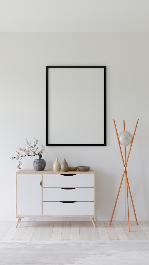 A white room with a wooden table and a picture frame