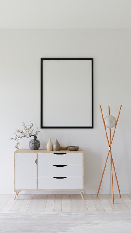 A white room with a wooden table and a picture frame