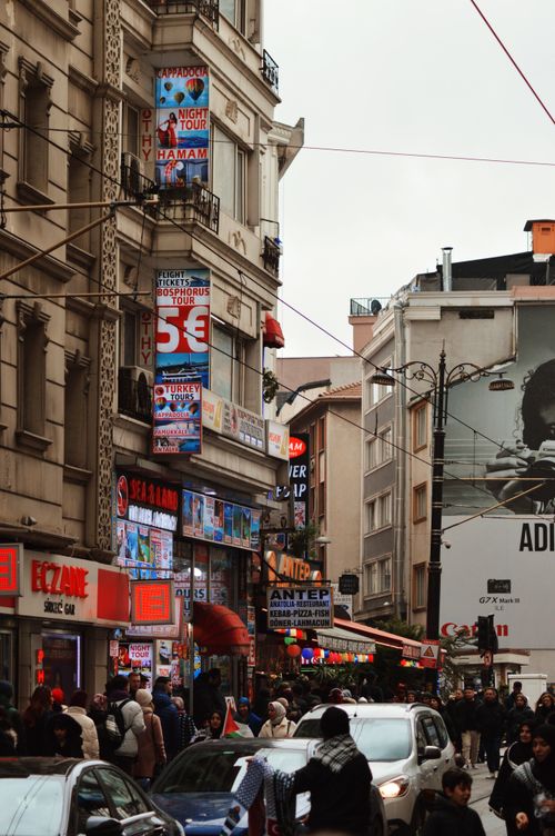 Free Lively street in Istanbul featuring people, cars, and historical architecture, capturing the essence of urban life. Stock Photo