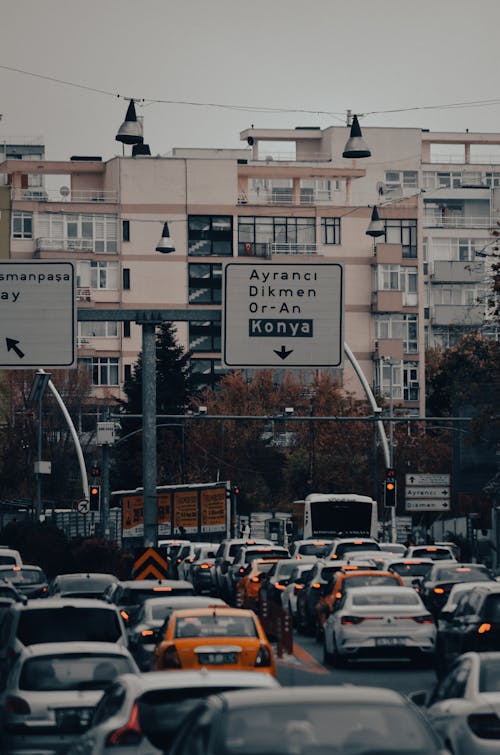 A city street with cars and traffic signs