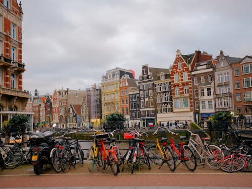 A row of bicycles parked in front of buildings