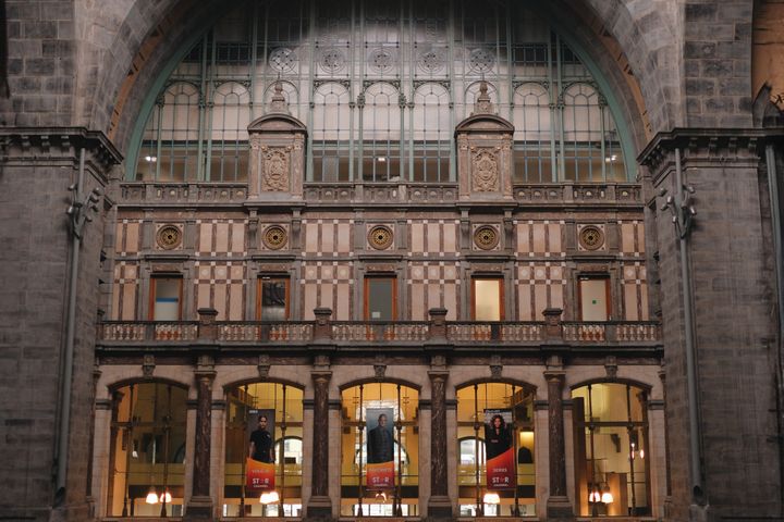 The inside of a train station with a clock