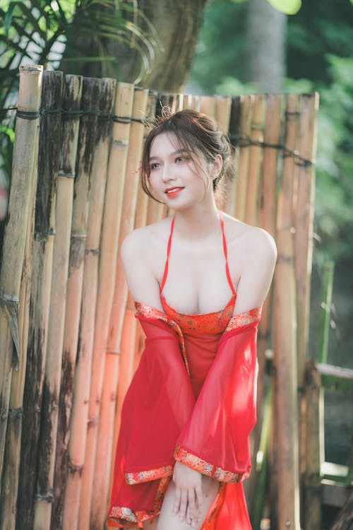 A woman in a red dress posing for the camera