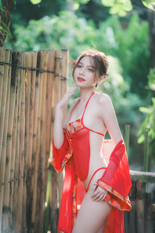 A woman in a red bathing suit posing for the camera