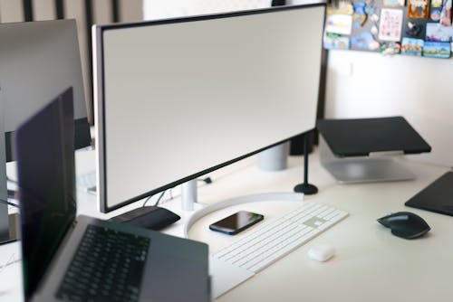 Screen and Laptop on a Desk 