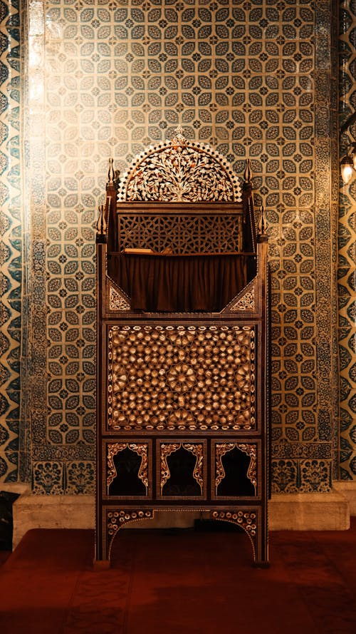 A wooden cabinet with ornate designs on the wall
