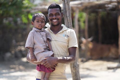 Free A father holds his son in a rural environment, showcasing joy and family connection. Stock Photo