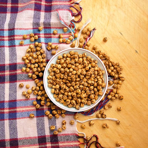 A bowl of chickpeas on a plaid cloth