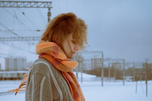 A woman in a scarf standing in the snow