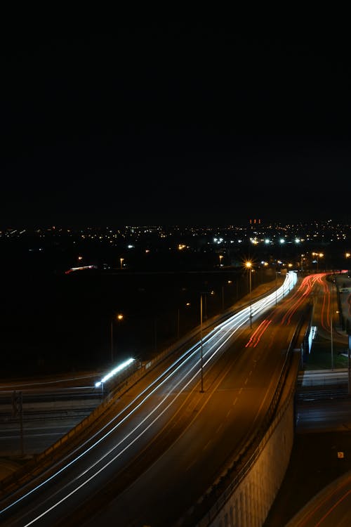 A long exposure photograph of a highway at night