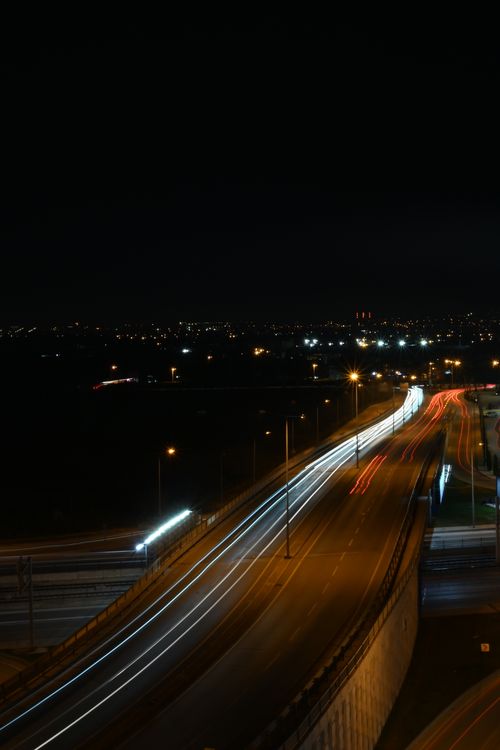 Free Long exposure aerial shot capturing city traffic lights at night. Stock Photo