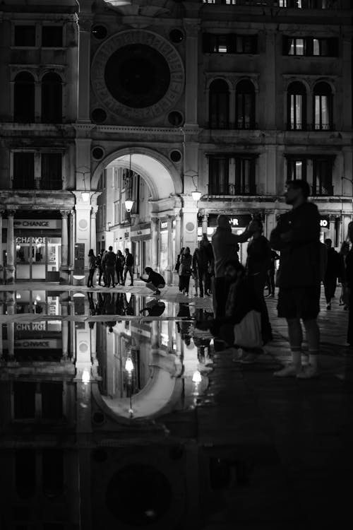 Black and white photo of people walking in the rain