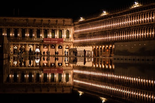 View of Illuminated Buildings and Flooded Piazza San Marco at Night in Venice, Italy 