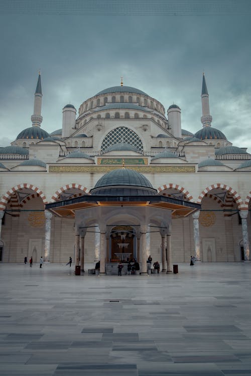 A large mosque with two domes and a large clock