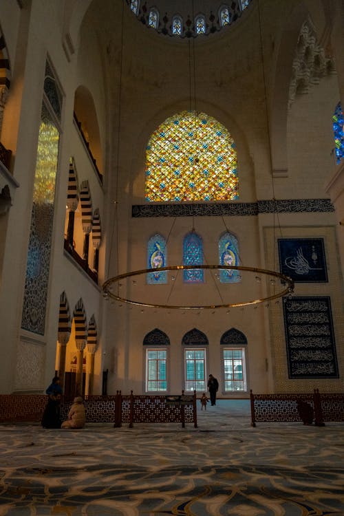 The interior of a mosque with stained glass windows