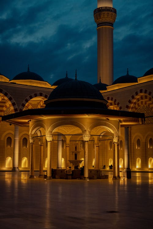 The mosque at night with lights on
