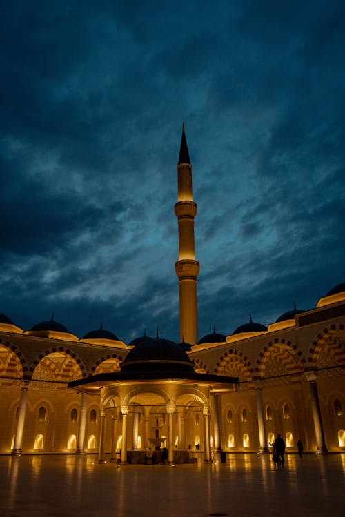 The mosque at night with a clock tower in the background