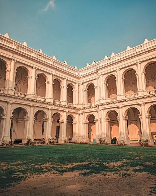 The courtyard of a building with arches and columns