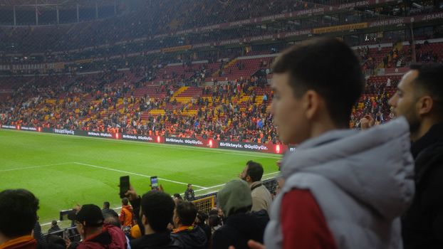 Crowd at a thrilling soccer match in Istanbul stadium with vibrant atmosphere.