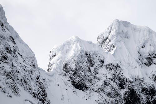A person is standing on top of a snowy mountain