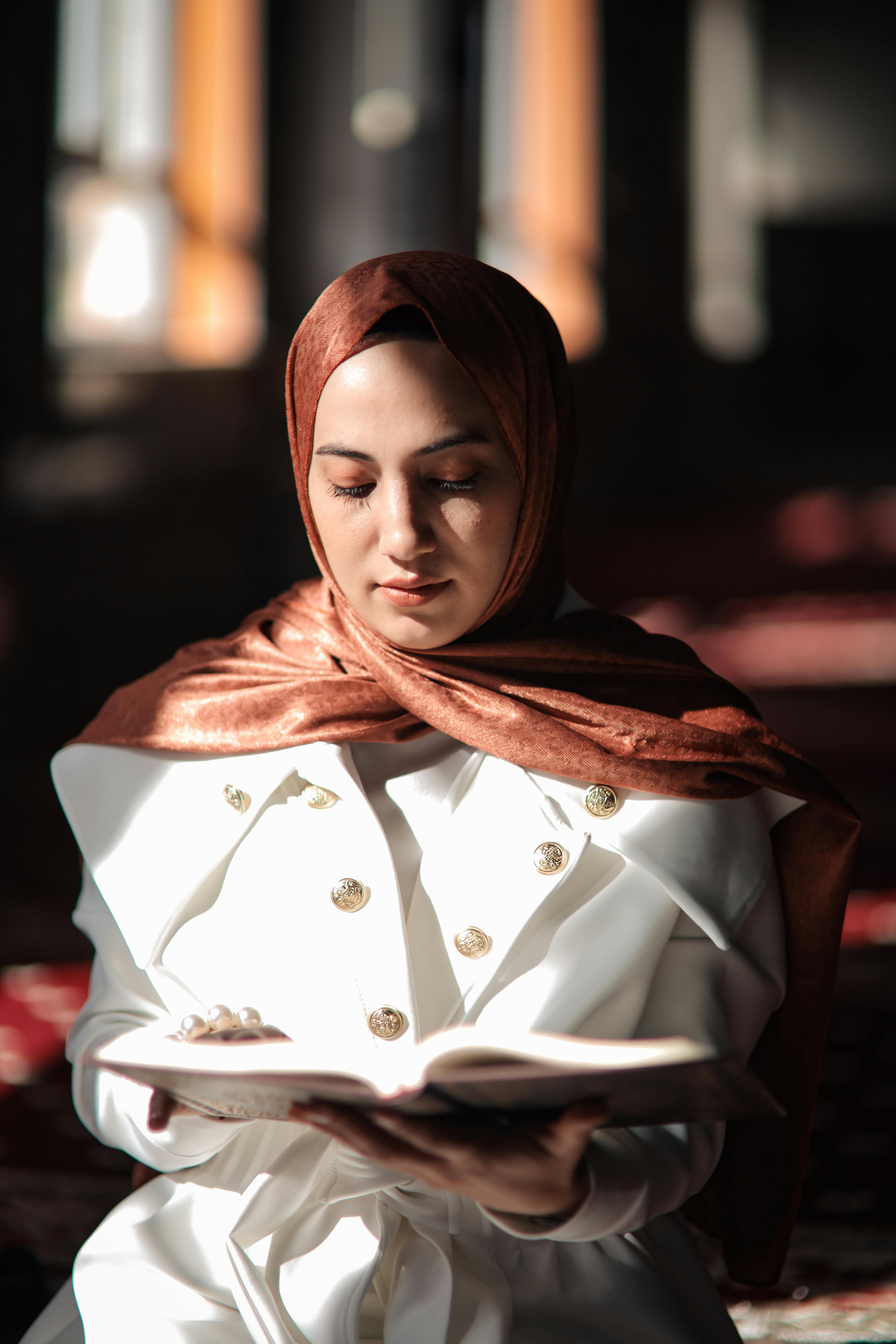 portrait of woman reading koran