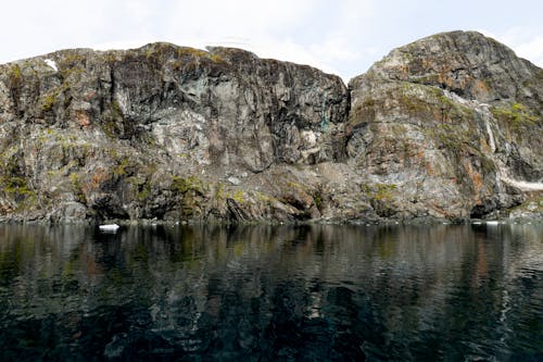 A large rock formation in the middle of the water