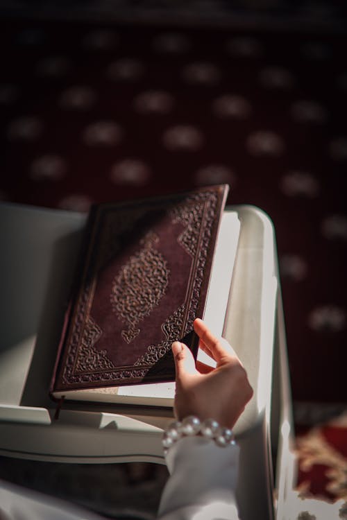 Woman Holding Koran in a Mosque 