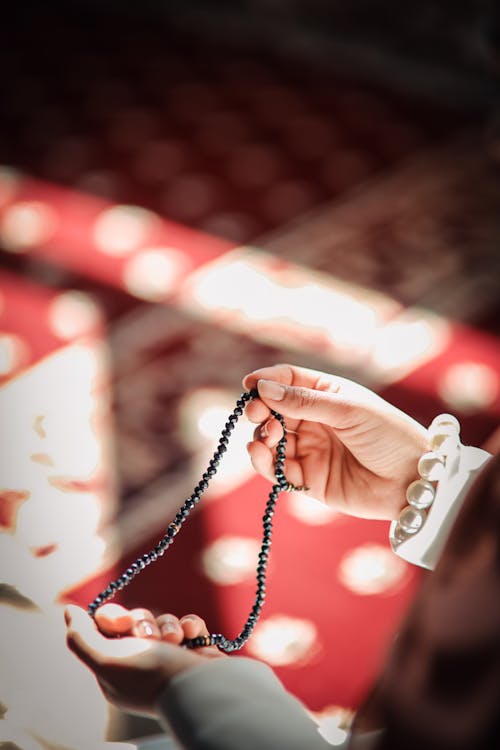 Woman Hands Holding Rosary