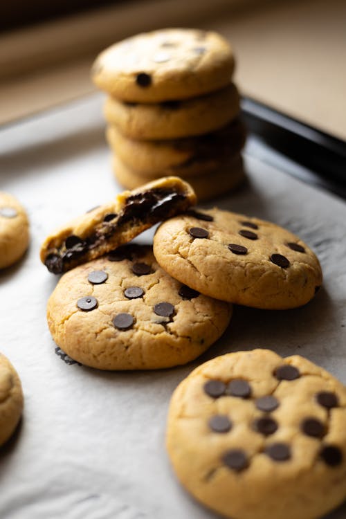 Chocolate chip cookies on a baking sheet with one cookie missing