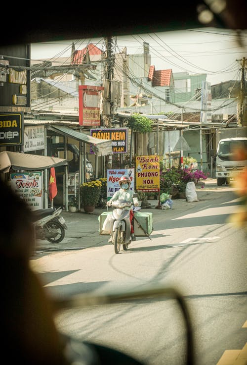 A view of a street with a motorbike and a building