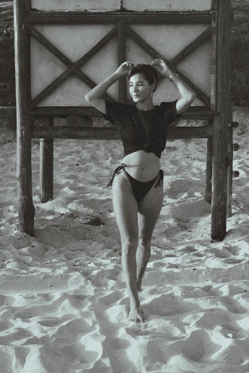A woman in a bikini standing on the beach