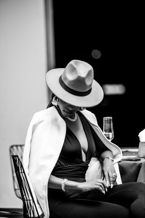 A woman in a hat sitting at a table