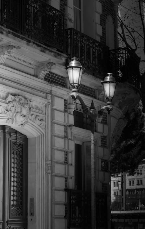 A black and white photo of a street lamp