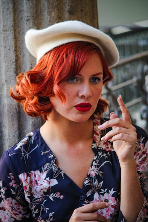 A woman with red hair and a beret