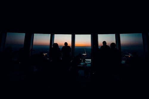 Silhouette of people in a room at sunset
