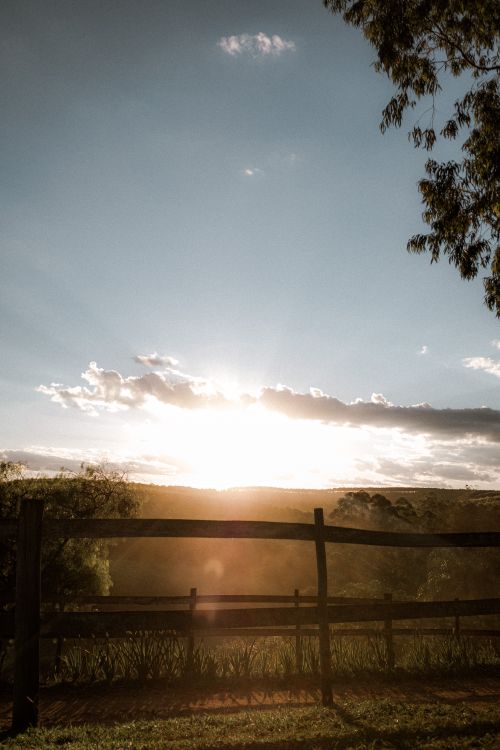 Free Captivating sunset view over a wooden fence in the serene countryside of Itirapina, SP, Brazil. Stock Photo