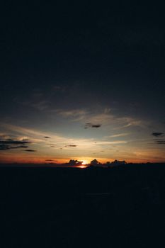 A breathtaking sunset over the rural countryside of Itirapina, Brazil, showcasing vibrant hues and tranquil scenery.