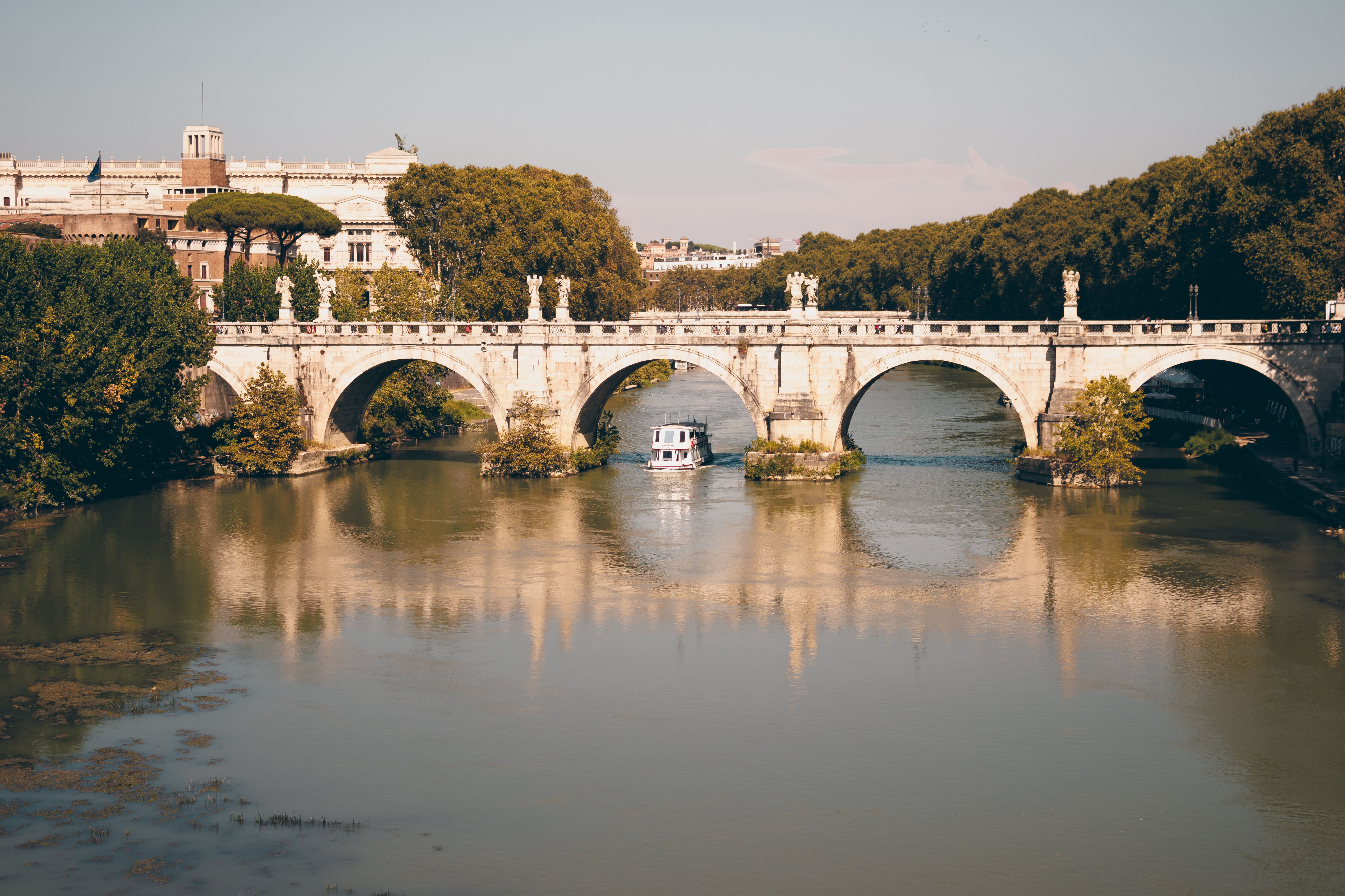 A scenic view of Sant'Angelo Bridge spanning the Tiber River in Rome, Italy.