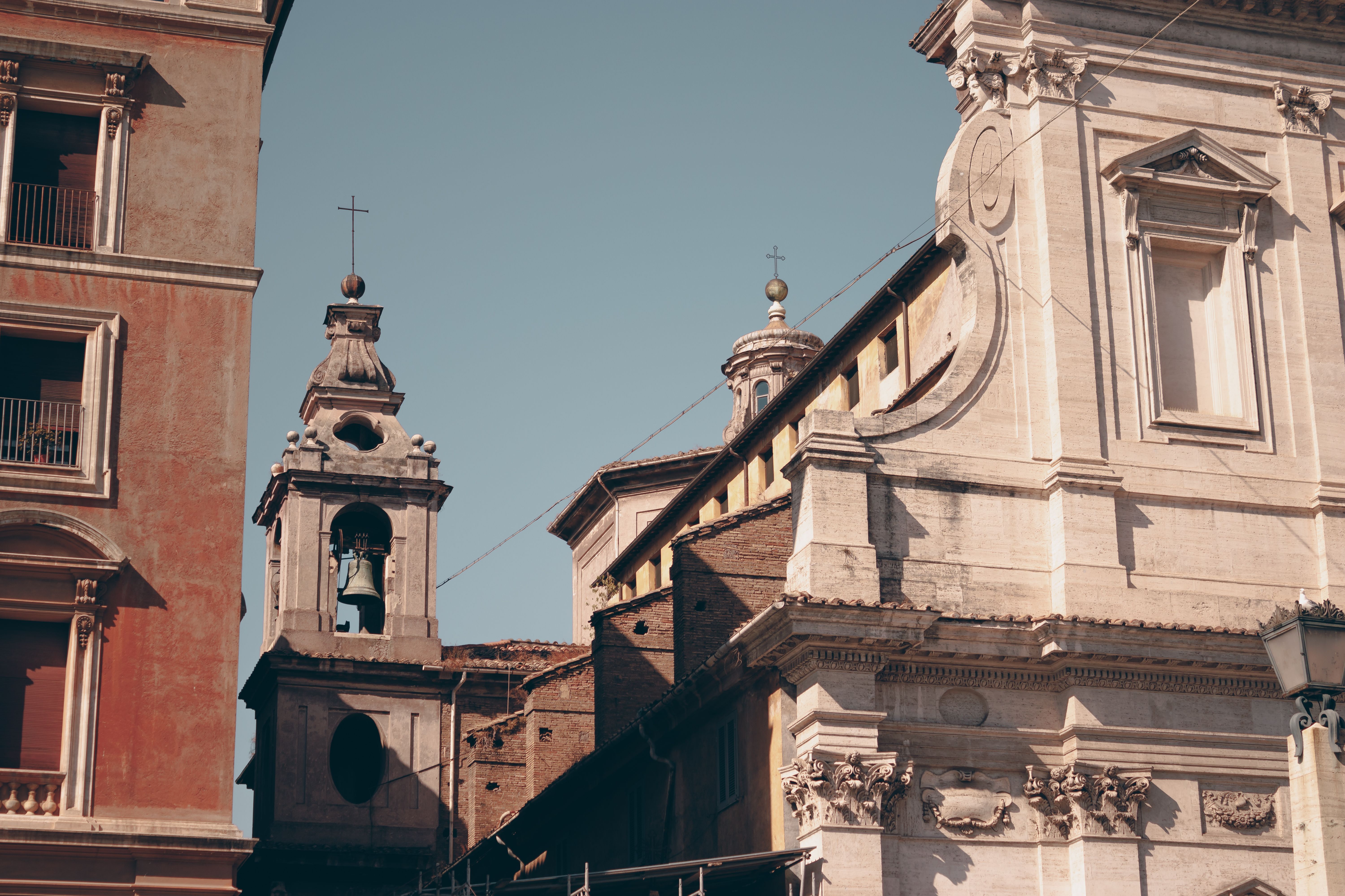 Historic Roman buildings with intricate architectural details under a blue sky