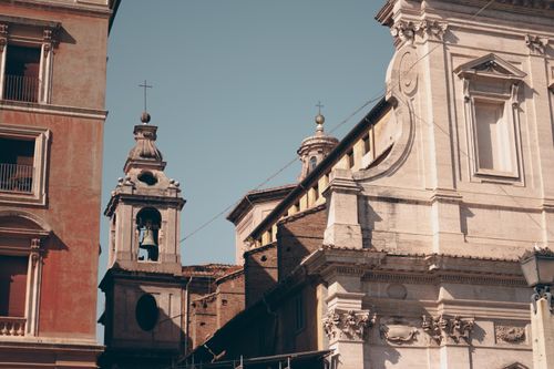 Free A captivating view of historic Roman buildings with intricate details under a clear blue sky. Stock Photo